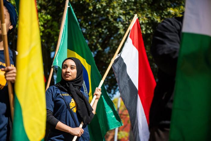 Female student holding a flag during the global cultural festival.