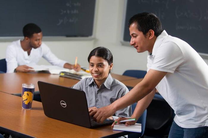 Student receiving help on the computer.