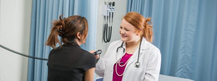 Health provider examining a patient.