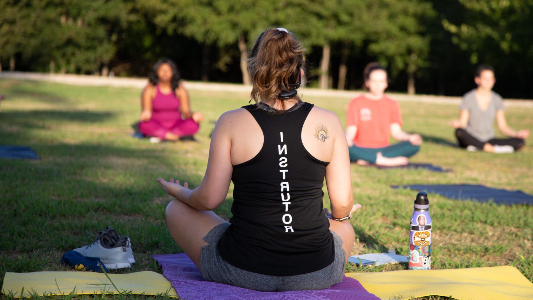 A Campus Recreation instructor leading a yoga session.