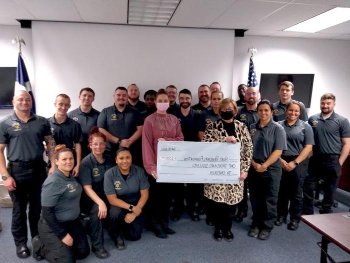 Cadets present a check to Texas Oncology