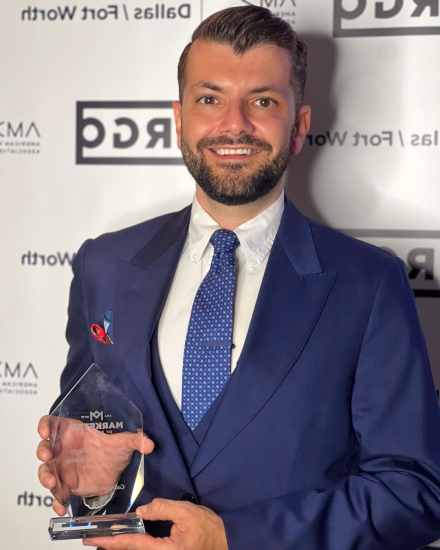 A person holding an award trophy